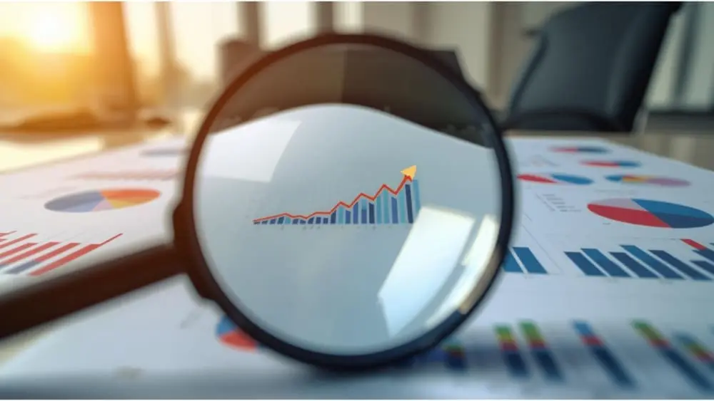 Why Cutting Marketing Budgets Costs More Than You Think - Magnifying glass looking at graph